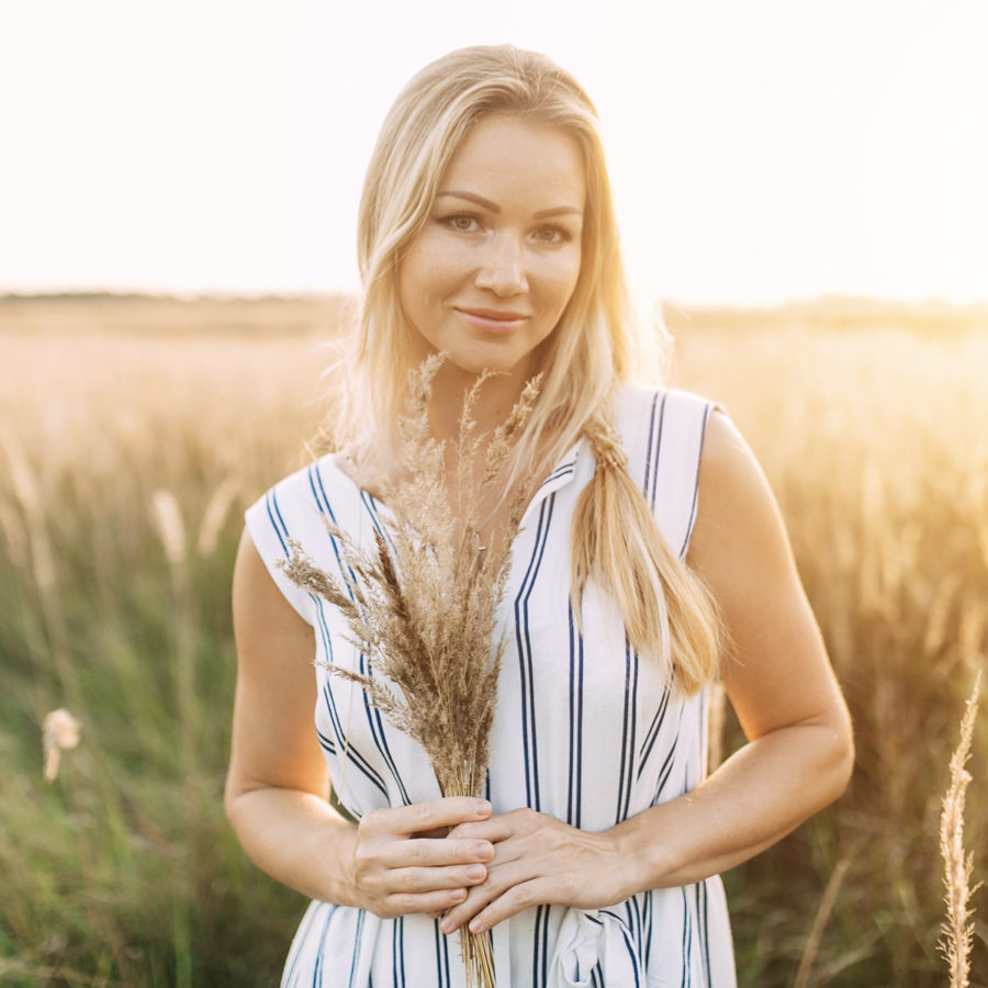 A stunning blonde woman in a field with Dr. Jack Peterson and a Microdermabrasion device.